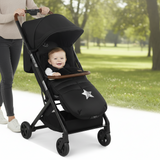 Black stroller with a matching footmuff featuring a star design on a white background