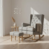 Gray rocking chair with tufted backrest and matching ottoman on a white background