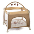 Beige baby playpen with hanging toys on a white background