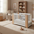 Set of four wooden cribs with white panels on a white background